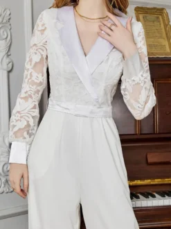 Combinaison blanche à manches longues en dentelle taille haute et jambes larges style nuptial.