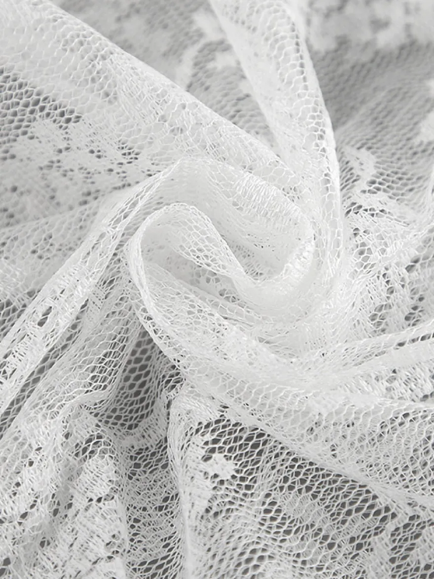 Jupe longue à volants en dentelle florale transparente à taille élastique noire et blanche transparente.