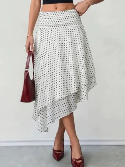 Jupe midi blanche à petits pois taille haute ourlet asymétrique à volants irréguliers en mousseline fluide.