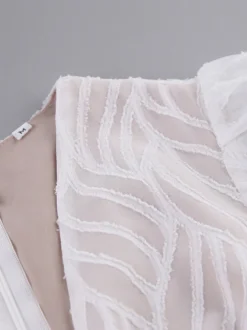 Mini-robe en jacquard à col en V et manches longues pour l'été 2026