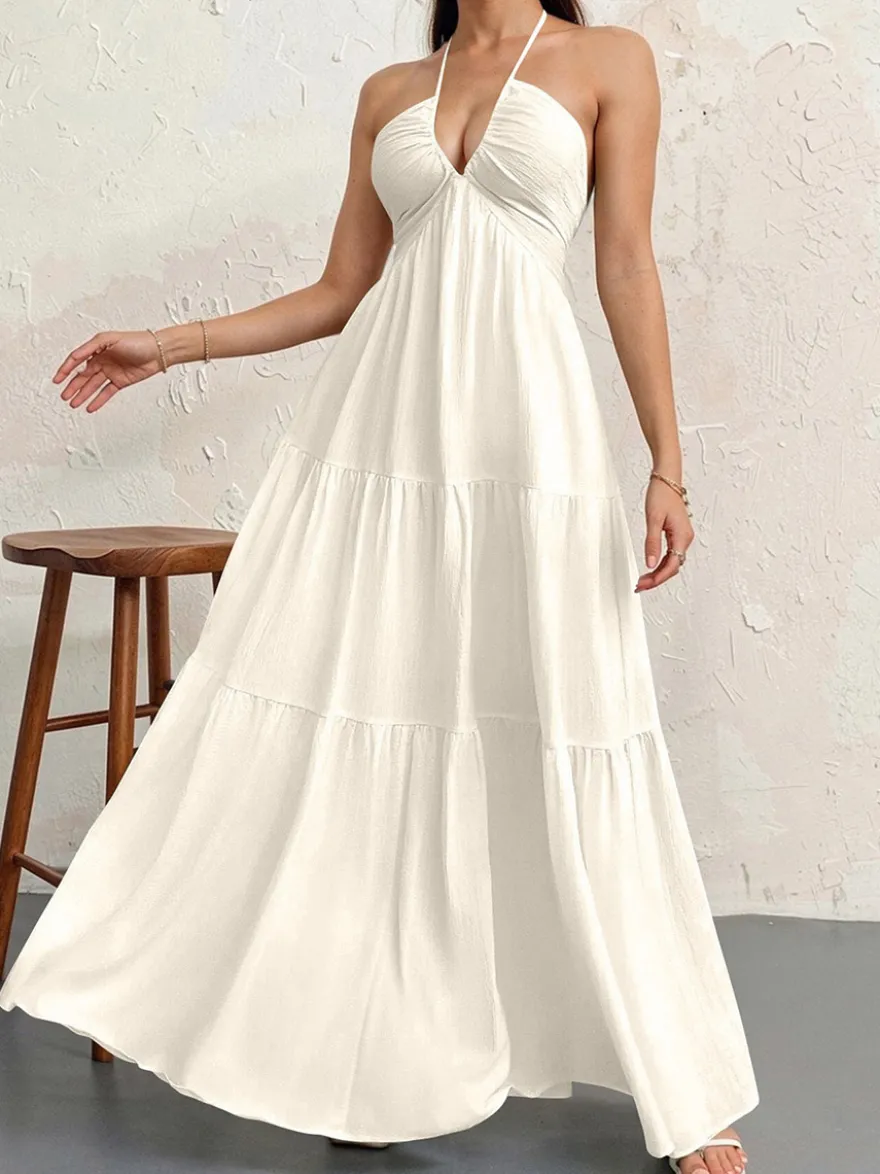 Robe de plage longue maxi fluide à dos nu et col halter en V ornée de volants superposés idéale pour les vacances d'été.