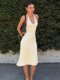 Robe de soirée Daily Dresses crème dos nu plongeant col en U ourlet fluide coupe midi bretelles fines et décolleté en U.