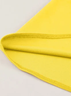 Robe jaune dos nu vintage swing avec ceinture blanche contrastante style rockabilly rétro années 50