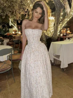 Robe longue bustier à bretelles spaghetti et imprimé floral discret style trapèze idéale pour une soirée romantique.