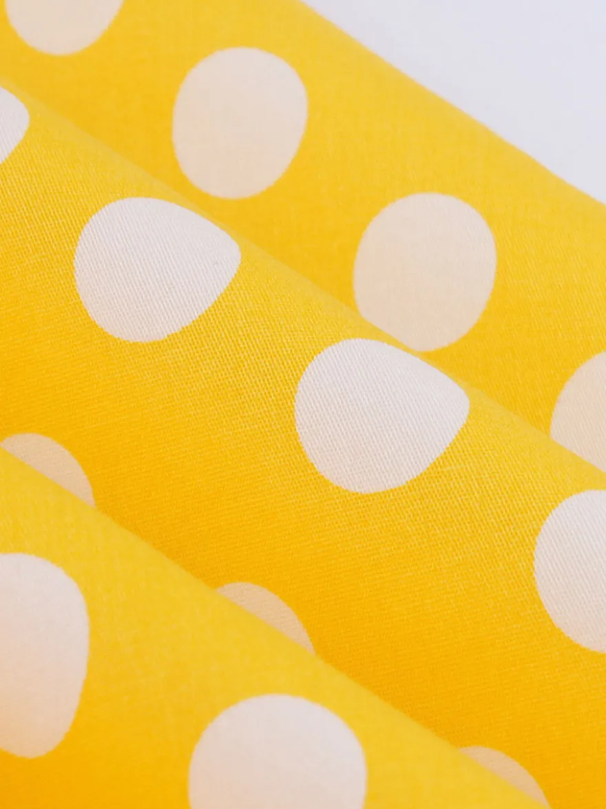 Robe midi vintage à pois bretelles doubles nœud sur le devant coupe trapèze jaune