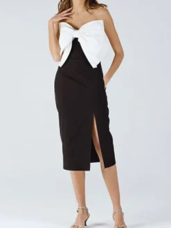 Robe noire chic à bretelles dos nu et sans manches ornée de nœuds idéale pour une soirée romantique.