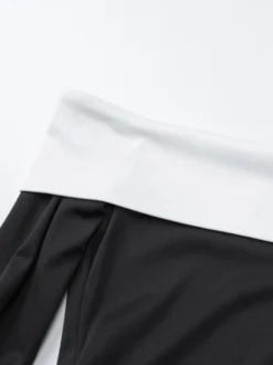 Robe noire chic à manches longues et mini bicolore épaules dénudées idéale pour un rendez-vous galant.