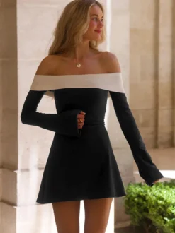 Robe noire chic à manches longues et mini bicolore épaules dénudées idéale pour un rendez-vous galant.