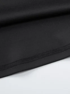Robe noire chic à manches longues et mini bicolore épaules dénudées idéale pour un rendez-vous galant.