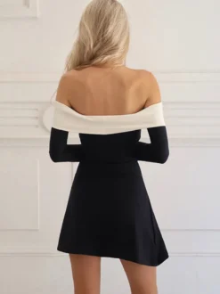 Robe noire chic à manches longues et mini bicolore épaules dénudées idéale pour un rendez-vous galant.