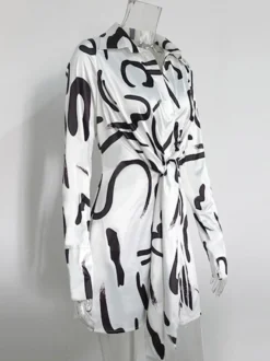 Robe noire élégante à manches longues et coupe asymétrique idéale pour tous les jours.