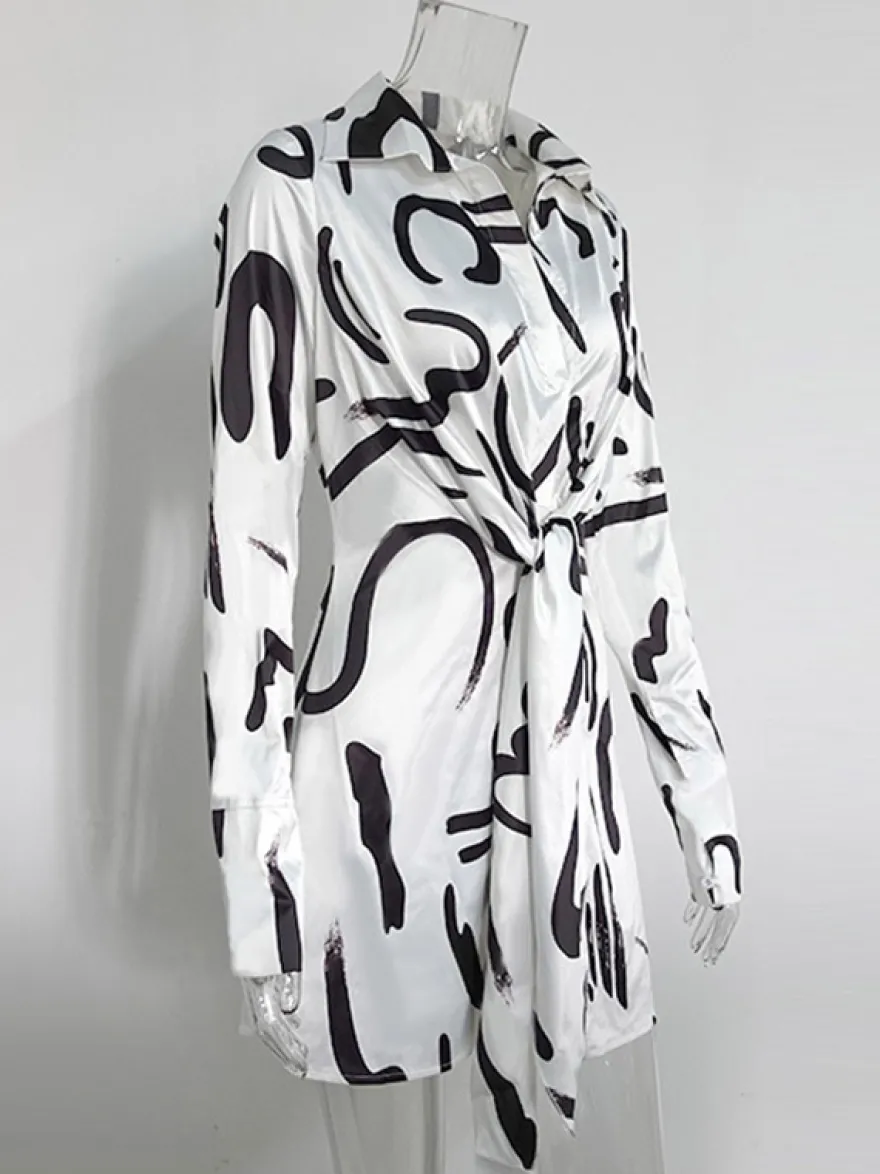Robe noire élégante à manches longues et coupe asymétrique idéale pour tous les jours.