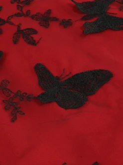 Robe rétro glamour années 50 noire bicolore à volants brodée sans manches col en V style rockabilly